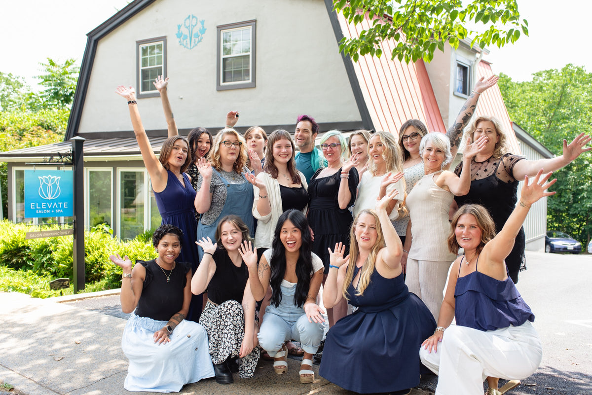Elevate team celebrating in front of the salon at Elevate Salon + Spa, Charlottesville VA