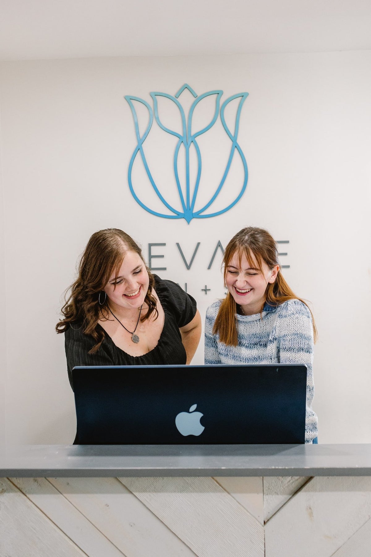 Front desk team at the reception computer at Elevate Salon + Spa, Charlottesville VA