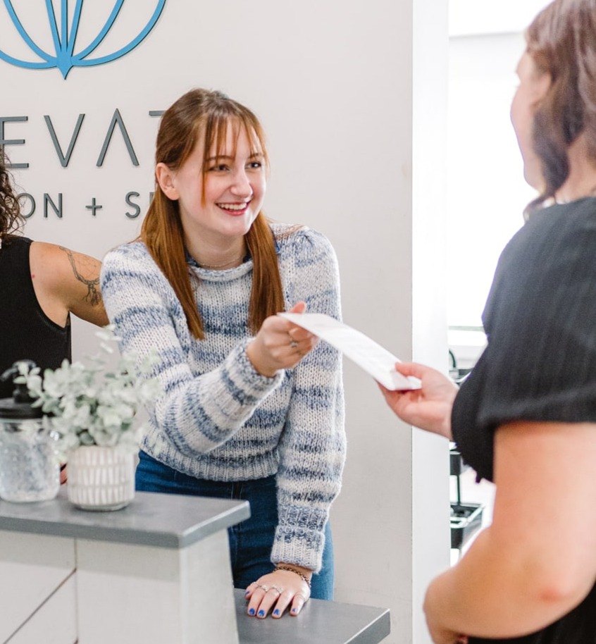 Guest checking in at the front desk at Elevate Salon + Spa, Charlottesville VA