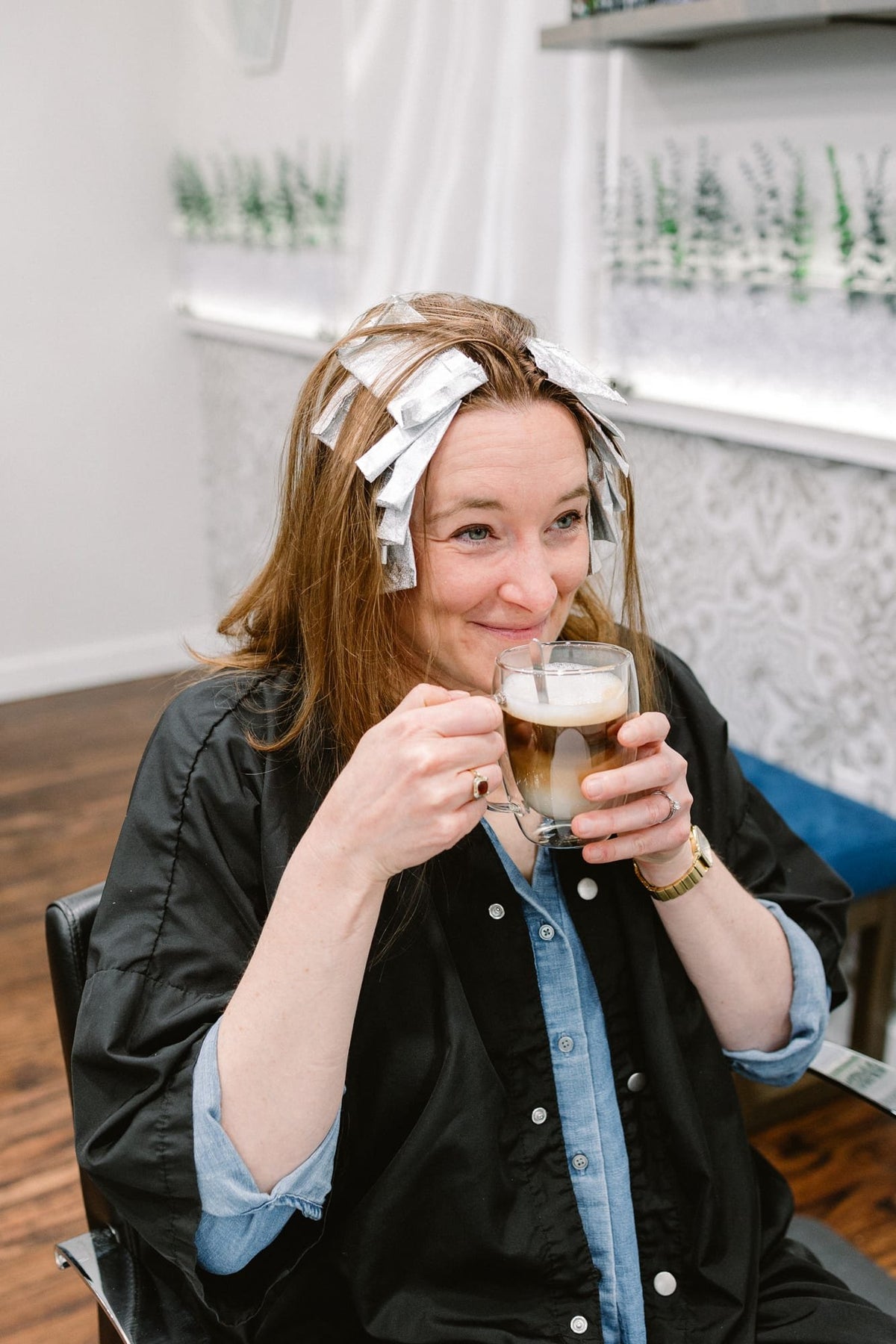 Guest enjoying a latte during a color service at Elevate Salon + Spa, Charlottesville VA