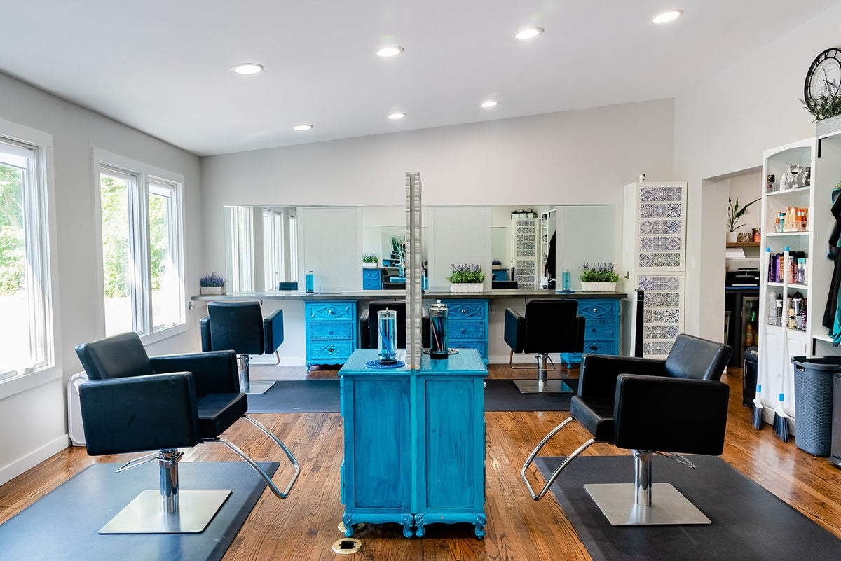 Open styling floor with teal stations at Elevate Salon + Spa, Charlottesville VA