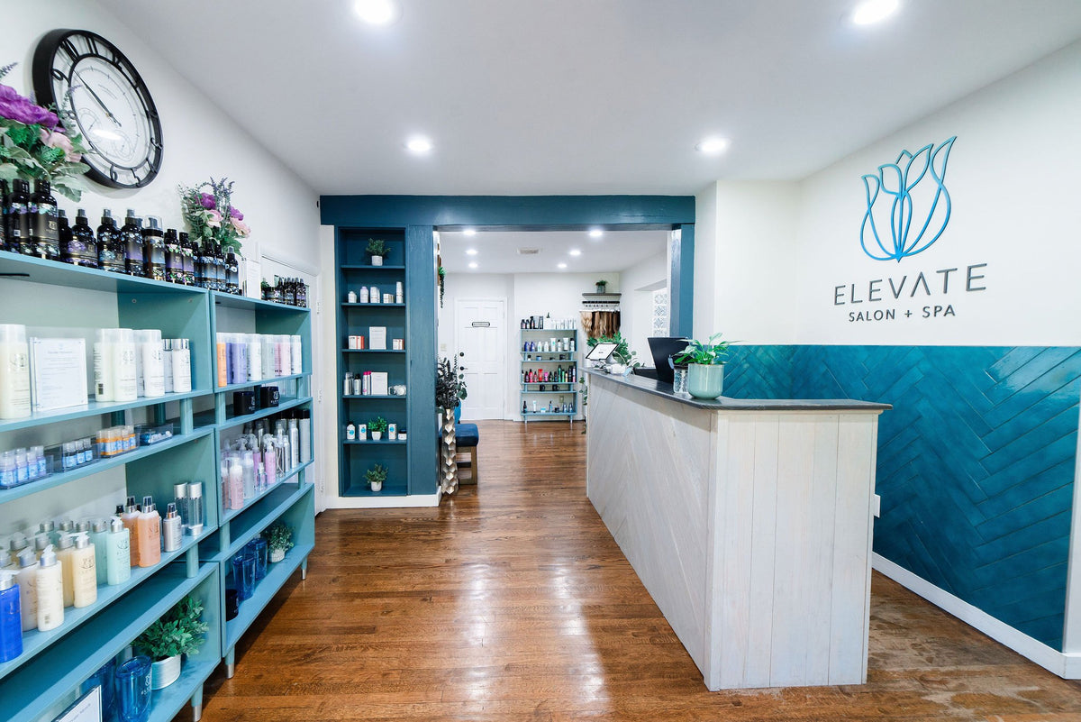 Retail wall and front desk with Elevate logo at Elevate Salon + Spa, Charlottesville VA