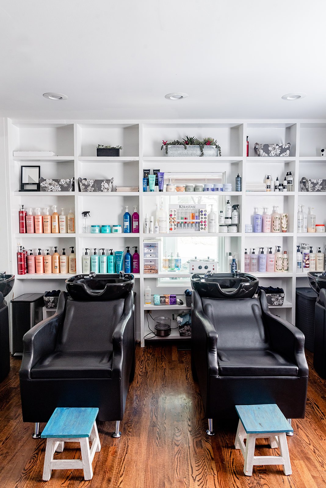 Shampoo bowls beneath the color bar at Elevate Salon + Spa, Charlottesville VA