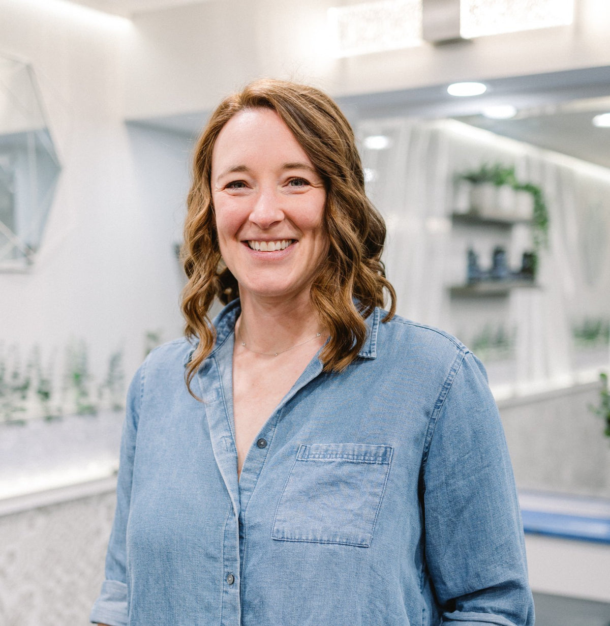 Smiling guest with auburn waves at Elevate Salon + Spa, Charlottesville VA