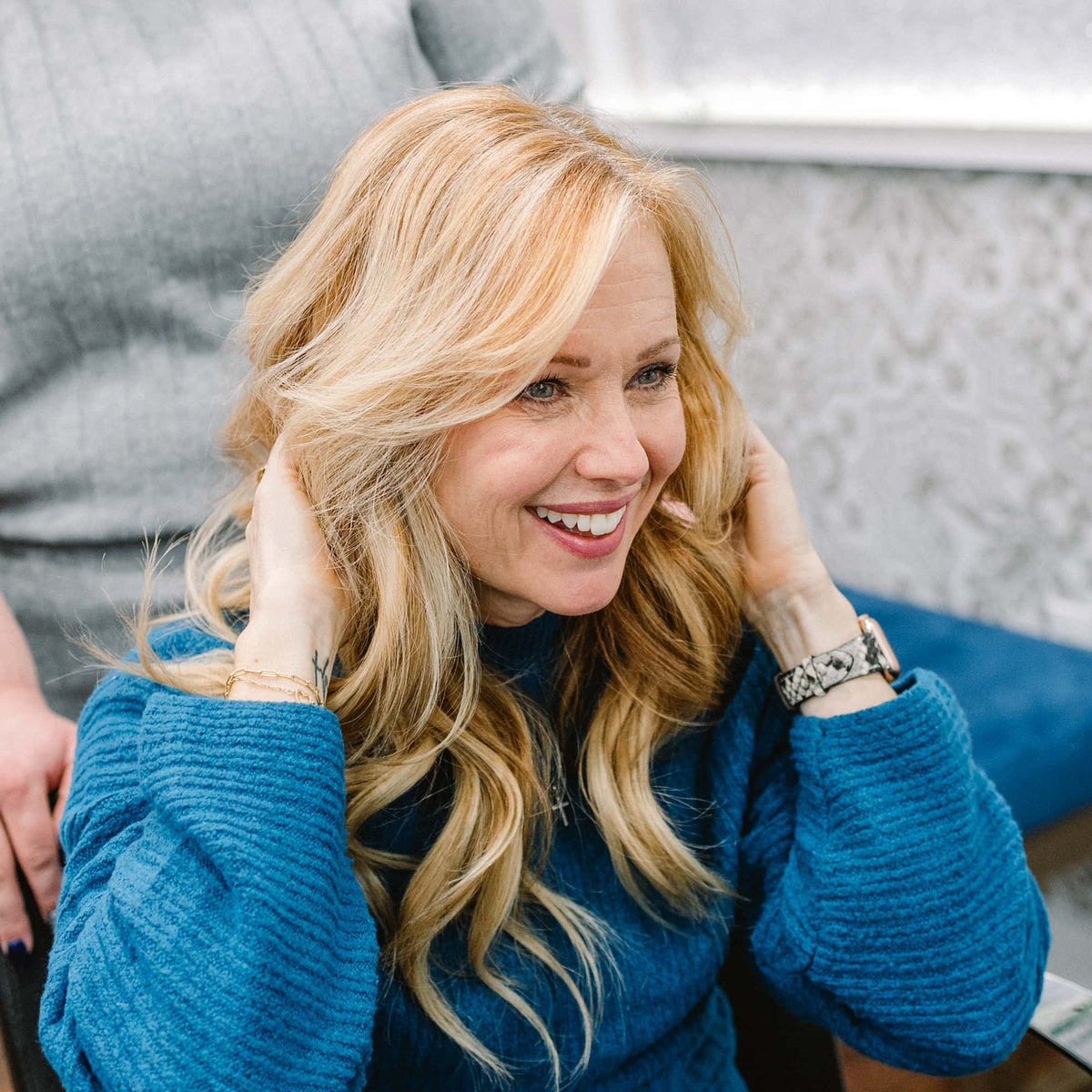 Smiling guest with fresh blonde waves at Elevate Salon + Spa, Charlottesville VA