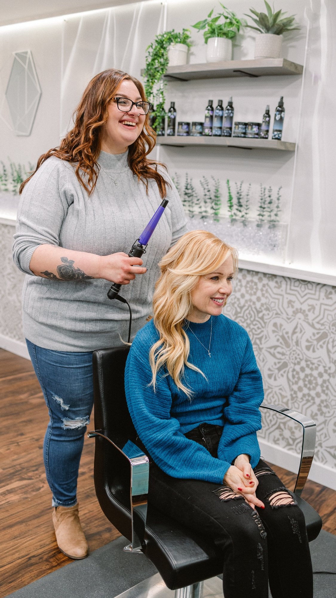 Stylist curling a guest's blonde hair at Elevate Salon + Spa, Charlottesville VA