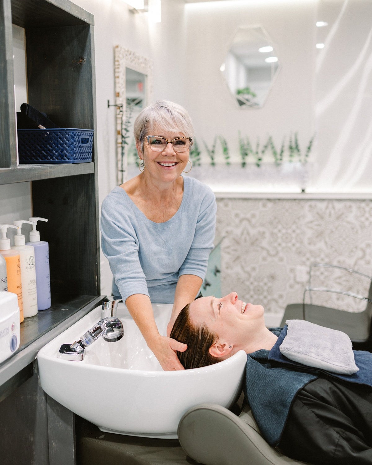 Stylist shampooing a guest at Elevate Salon + Spa, Charlottesville VA