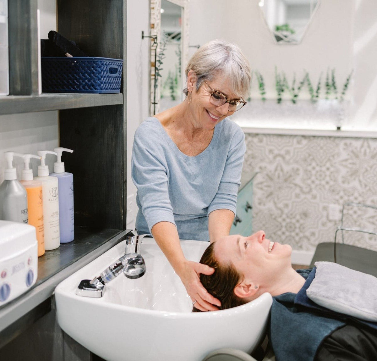 Stylist shampooing a guest at Elevate Salon + Spa, Charlottesville VA