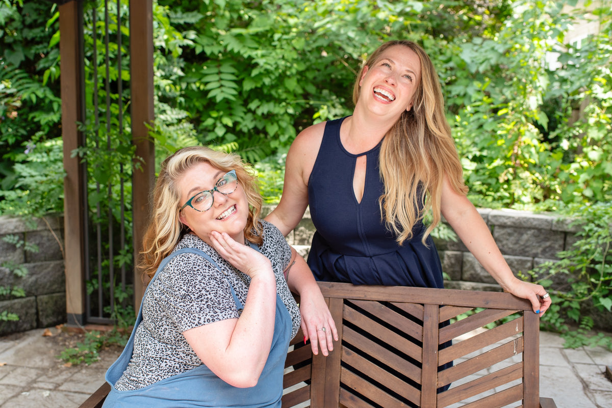Two Elevate stylists laughing in the garden at Elevate Salon + Spa, Charlottesville VA